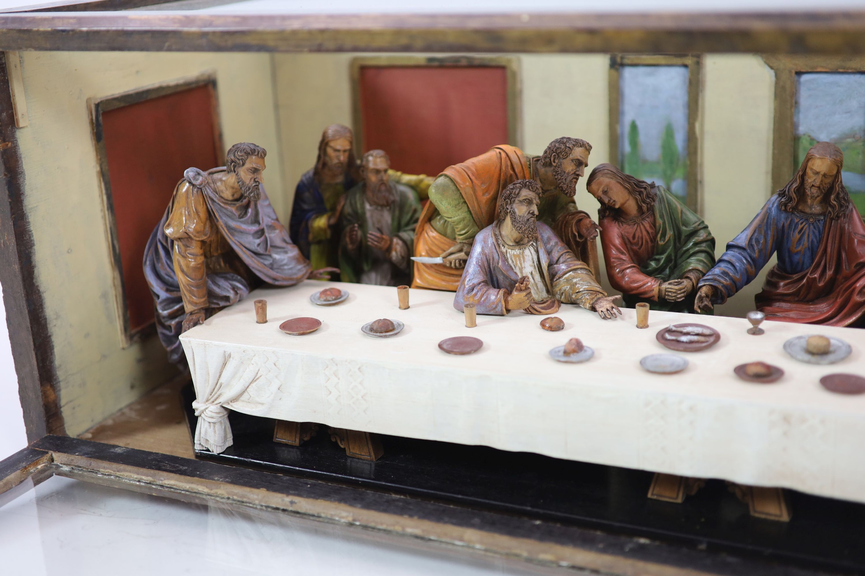 Attributed to Hans Mayr (active 1870) - a carved and painted limewood tableau of The Last Supper, after Leonardo da Vinci, dated 1872 32cm high, 94 x 33cm.